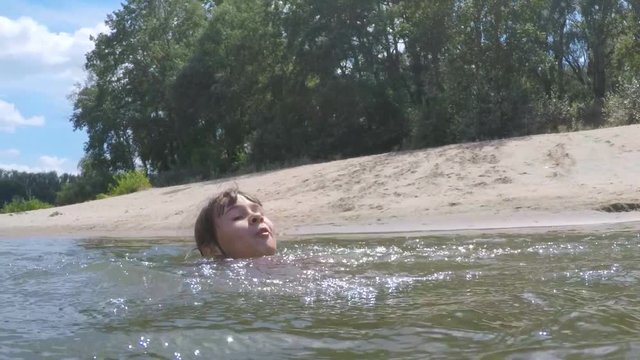 Little girl learns to swim. The child is drowning in the water.