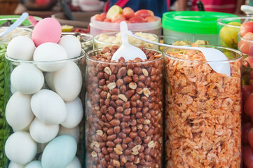 High glass jar contain seasoning roasted peanut dried shrimp and tomato