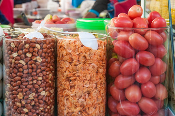 High glass jar contain seasoning roasted peanut dried shrimp and tomato