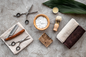Preparing for men shaving. Shaving brush, razor, foam, sciccors on grey stone table background top view