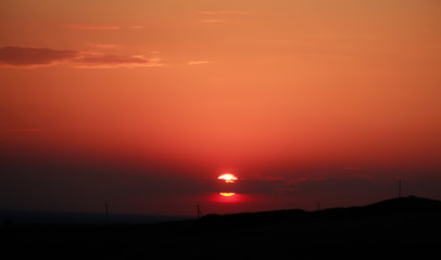 Sunset on the horizon in the field