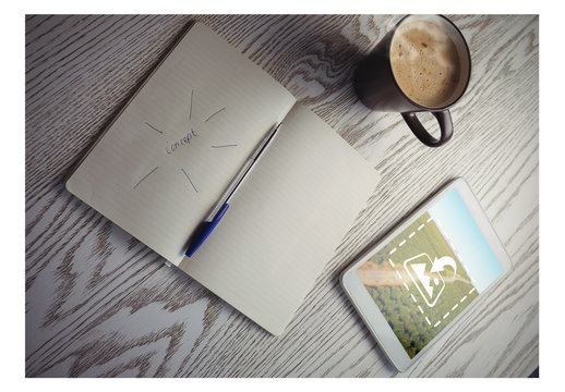 Tablet on Table with Coffee Mug and Notebook Mockup 1