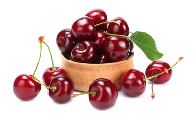 cherries in wooden bowl isolated on white background.