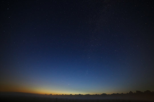 Stars of the Milky Way galaxy in the night sky. Space in the background of the morning dawn.