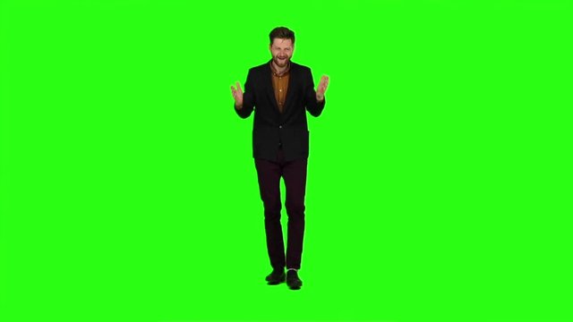 Young guy is happy with his victories, he is happy. Green screen. Slow motion
