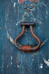 Fototapeta premium Brass knocker on old wooden door in Lisbon
