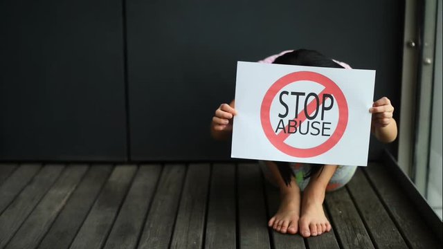 Young girl show child abuse sign.