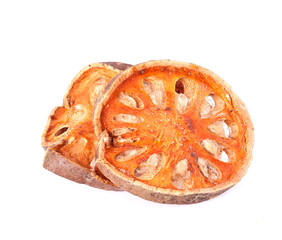 Slices of dried bael fruit on white background