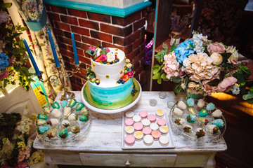 Obraz na płótnie Canvas Wedding cake. Candy bar marshmallow on the table in a vase, macaroon, and cupcake, decor vanilla, handmade sweets. Top view