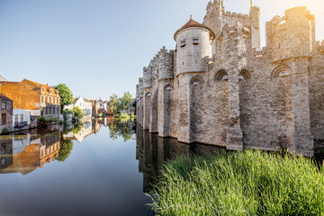Riverside view with beautiful old buildings and castle walls during the morning light in Gent city,...