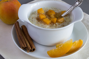 Healthy breakfast: oatmeal with milk in the white plate