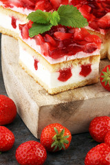 strawberry cake and many fresh strawberries on grey background