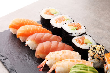 close up of sashimi sushi set with chopsticks and soy - sushi roll with salmon and sushi roll with smoked eel, selective focus.