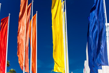 Colourful flags against the blue sky