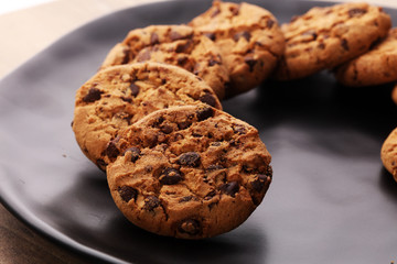 Chocolate cookies on wooden table. Chocolate chip cookies shot