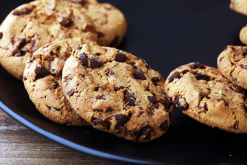 Chocolate cookies on wooden table. Chocolate chip cookies shot