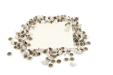 a bunch of thumbtack around a notice paper