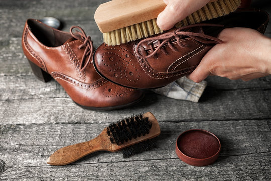 Worker cleaning shoe with brush