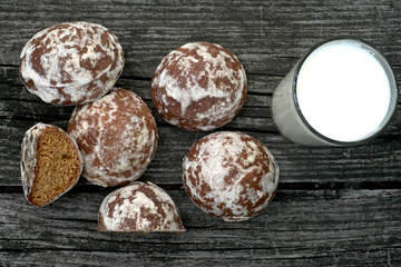 Cookies on a wooden table with a glass of milk