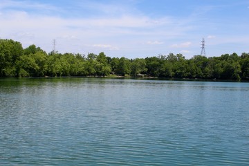 The fishing lake at the park on a sunny day.