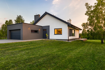 Stylish house with large lawn - obrazy, fototapety, plakaty