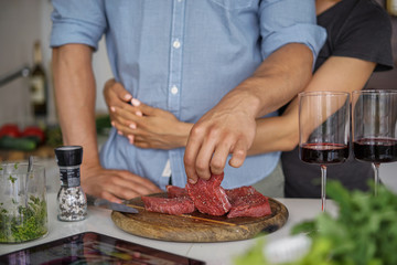 Couple Cooking meat together.  Hobby Lifestyle Concept