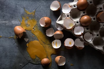 Keuken spatwand met foto tray of eggs theme broken on dark background © Hyper Bee