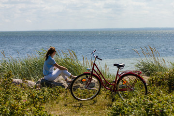 Fototapeta premium Woman with bike at seaside
