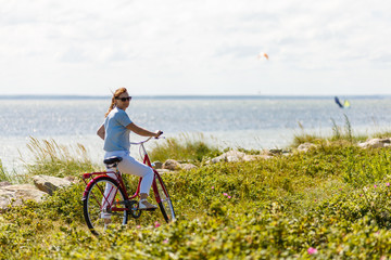 Woman with bike at seaside