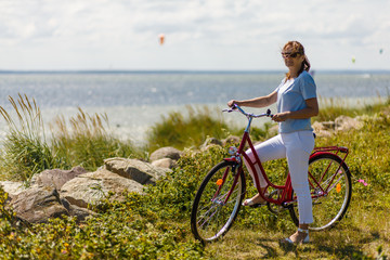 Woman with bike at seaside