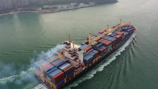 Hong Kong Aerial v168 Birdseye view flying low around large cargo ship passing by 2/17