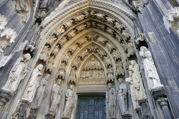 Gothic cathedral in Cologne. High medieval walls, numerous sculptures and decorations - an old building in the city center.