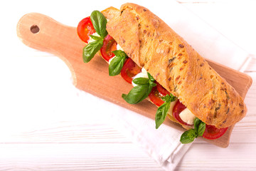 Ciabatta sandwich with caprese salad, basil, tomatoes, mozzarella