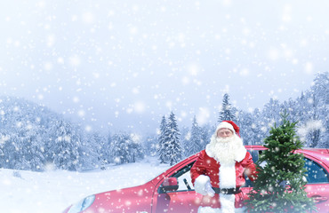 Santa Claus with Christmas tree near car in forest during snowfall
