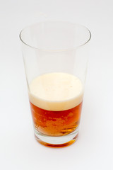 Amber Ale beer in glass on a white background.