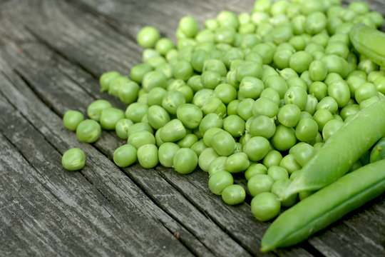 Green peas on a wooden table