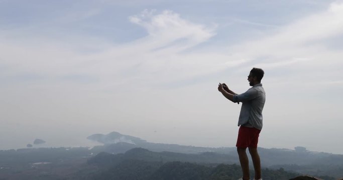 Man On Mountain Top, Male Tourist Taking Photo Of Morning Landscape On Cell Smart Phone Back Rear View Slow Motion 60