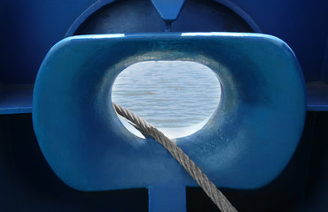 Hole in ship hull and hawser for berthing