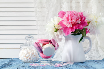 Bouquet of pink and white peony flowers on wall panelling background