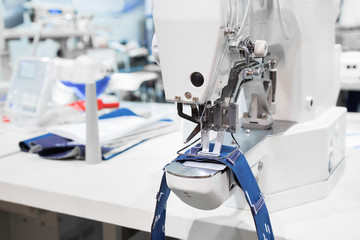 Sewing machine process a seam on jeans fabric