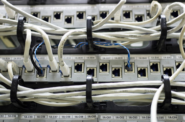 Close up of a server with many fiber optic network cables on a server rack
