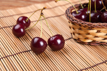 Ripe sweet cherry in the basket on a napkin
