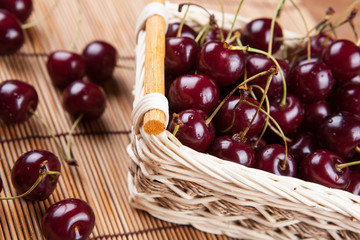 Ripe sweet cherry in the basket on a napkin