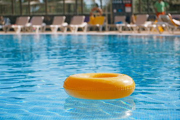 floating ring on blue water swimpool - 163851738