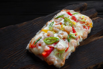  Delicious japanese rice pizza with shrimps served on rustic wooden table