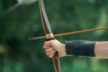 female archer hand keeping bow