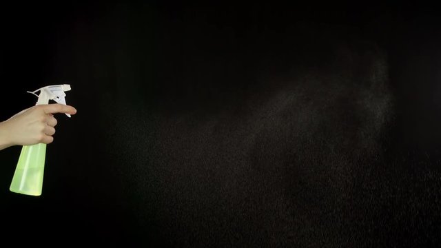 Spray Bottle spraying water. Slow motion.