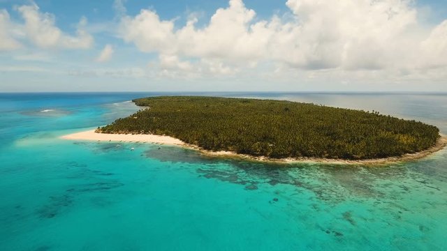 Aerial view of beautiful tropical island Daco with white sand beach. View of a nice tropical beach from the air. Beautiful sky, sea, resort. Seascape: Ocean and beautiful beach paradise. Philippines