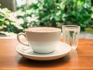 hot coffee cup on wood table.