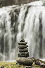 Stack of pebbles and waterfall